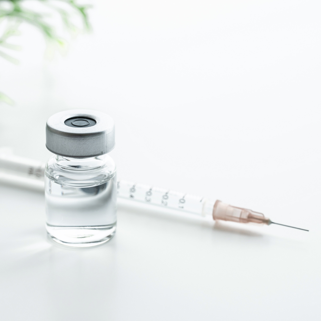 A close up of a vial and syringe.