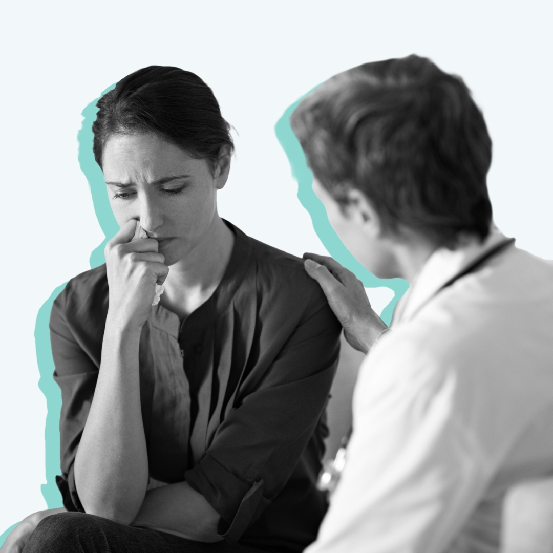 A nurse comforting a distressed family member.