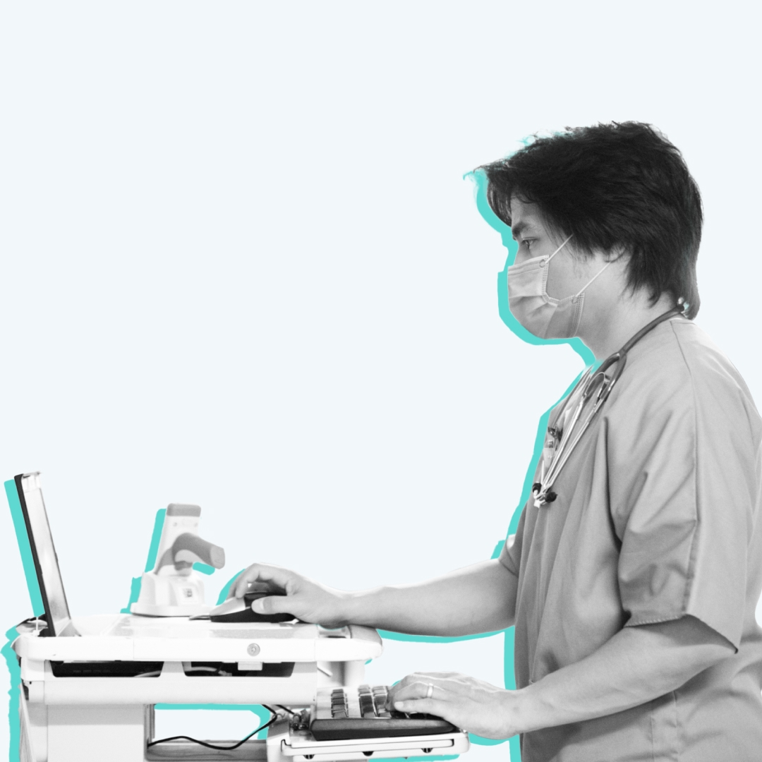 A nurse documenting on a mobile workstation.